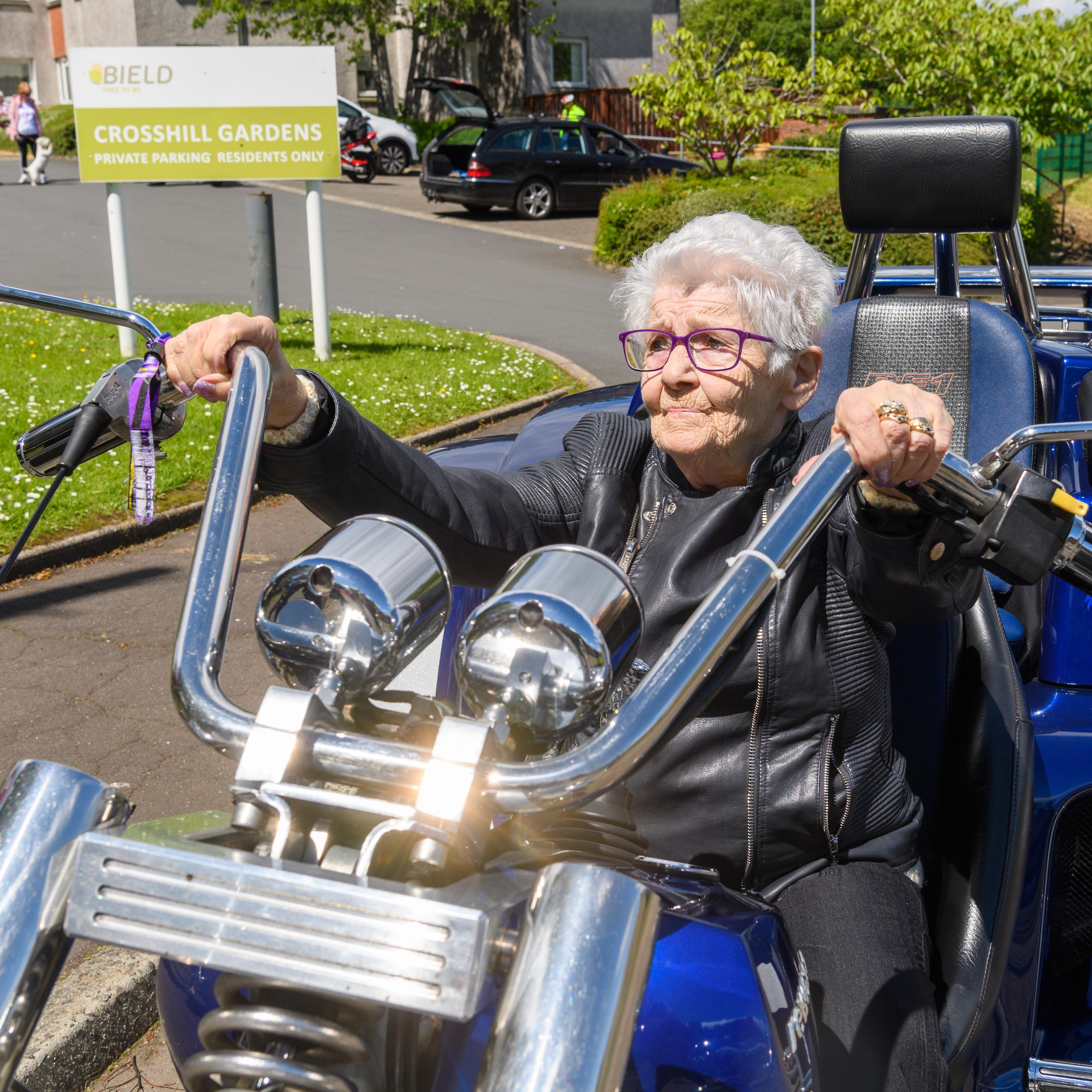 Margaret Sneddon in front seat of motorbike